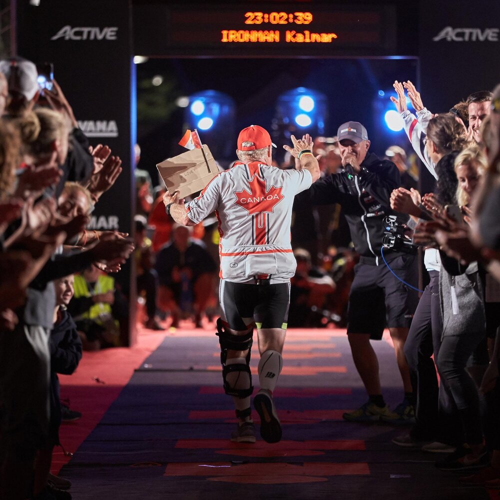 Denis crossing the finish line at IRONMAN Kalmar in Sweden&nbsp;on August 18, 2018